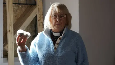 Oli Constable/BBC June Fox holding tea bags