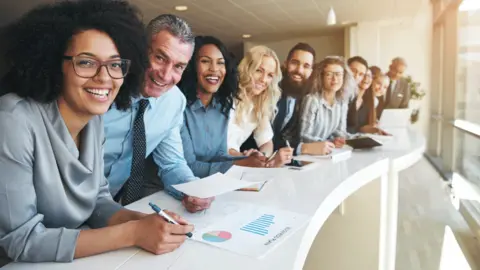 Getty Images A bunch of employees