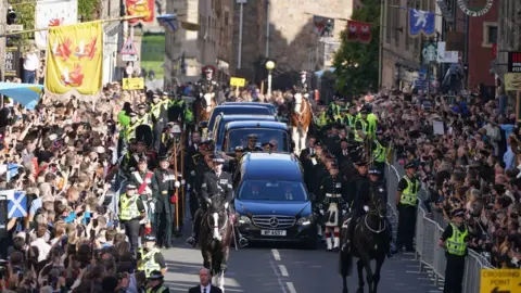 PA Media There was a solemn hush as the procession moved through crowds on the Royal Mile