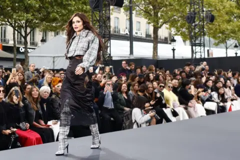 Getty Images Cheryl on the catwalk