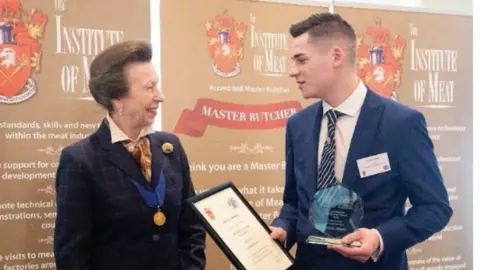 Family photo Sam Newey receiving an award from Princess Anne