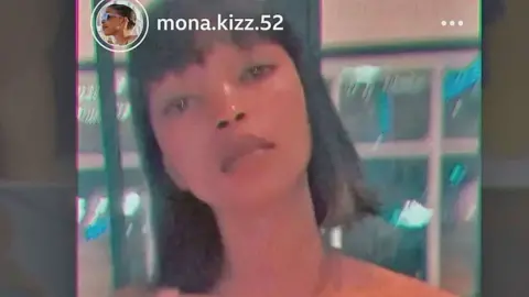 Instagram A grab of a social media video by Monic showing a young woman looking at the camera with dark hair cut straight to her shoulders and with a fringe