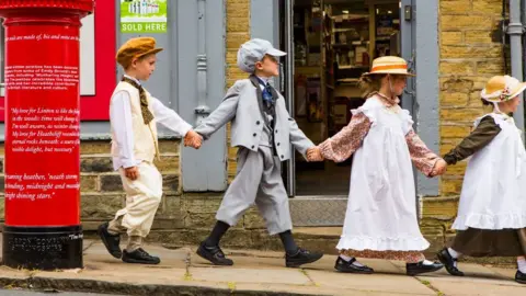 Royal mail Year Four children from Thornton Primary School dressed in 19th century clothes to post letters into the commemorative postbox