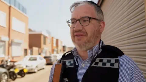 Isaac wearing a volunteer Shomrim vest