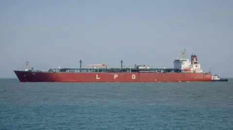 Reuters A large tanker with the letters "LPG" on it sits in the water. 