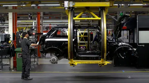 Getty Images A worker at BMW's Mini factory in Oxford