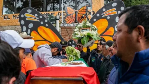 AFP People mourn next to the coffin with the remains of environmentalist Homero Gomez