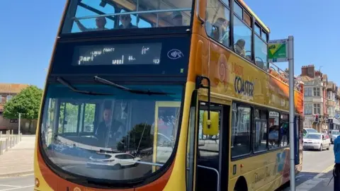 First Bus Jurassic Coaster yellow double-decker bus