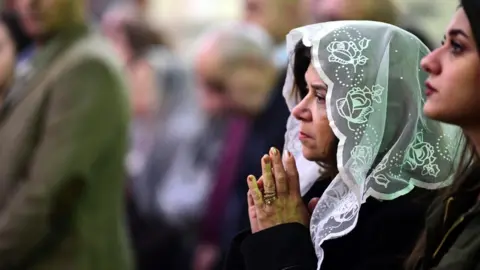 EPA Iraqi Christians attend a Christmas Mass at St. George Anglican church in Baghdad