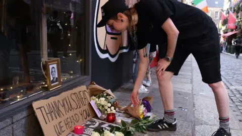 PA Media Mourner Lenny Coffey paid tribute to O'Connor at the Irish Rock 'n' Roll Museum in the Temple Bar area of Dublin