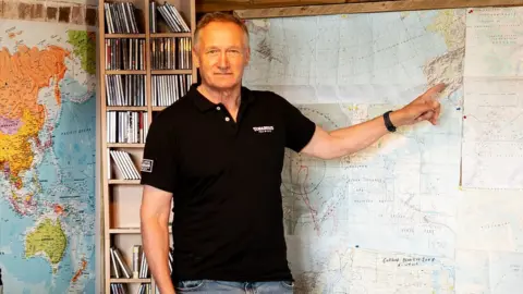 Torabhaig Single Malt Whisky David Hempleman-Adams pointing at a map