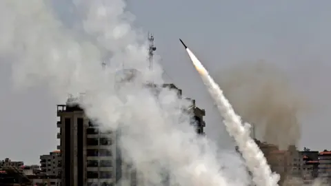 AFP A rocket is fired by Palestinian militant from Gaza City towards Israel on 11 May 2021