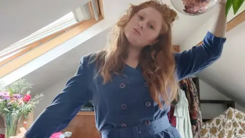 Amber Watson Amber wearing a blue thrifted outfit