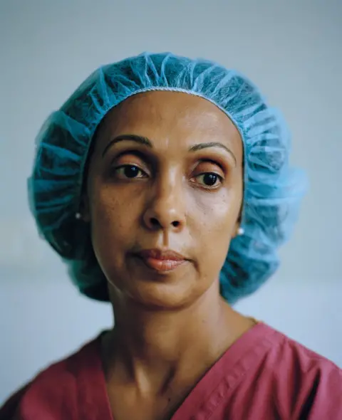 Lewis Khan A lady with her hair in a hair net