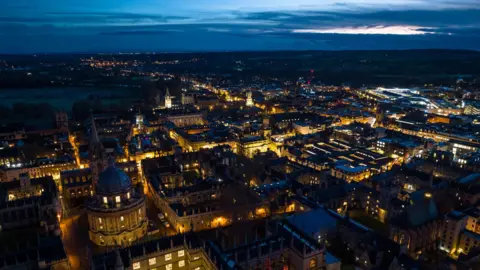 Getty Images A bird's eye view of Oxford at night, with the Radcliffe Camera and the historic centre of the city illuminated by electric lights 