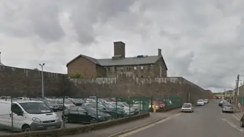 Google Streets around the back of Swansea prison are patrolled to stop people throwing items over the wall