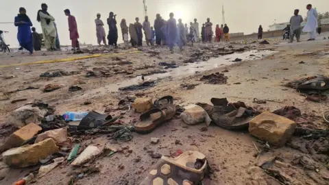 EPA-EFE/REX/Shutterstock Local residents gather at the scene of a suicide bomb blast in Mastung, Balochistan, Pakistan. Photo: 29 September 2023