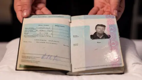 David Parry/PA Media Assignments An opened page from David Bowie's 1988 British passport. It includes his date of birth, height, and a photo of Bowie