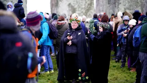Ben Birchall/PA People gathering at Stonehenge for the winter solstice