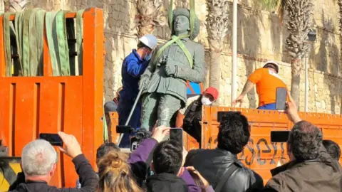 Getty Images Workers remove Franco's statue in Melilla on 23 February 2021