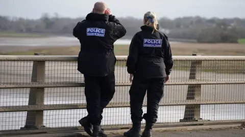 PA Media Police officers on the Shard Bridge on the River Wyre