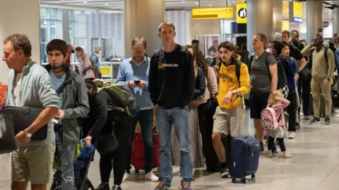Getty Images A long queue at Heathrow airport in 2022