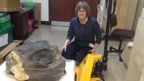 Caroline Butler with the fossilised eye of a sea dragon