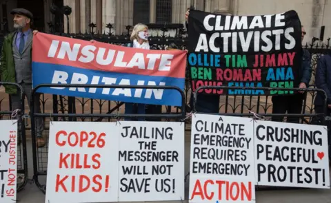 Getty Images Insulate Britain supporters protesting outside the Royal Courts of Justice after the sentencing on 17 November 2021