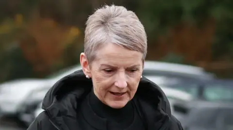 PA Media Lady Donaldson, with short grey hair, wearing a black top and black coat. 