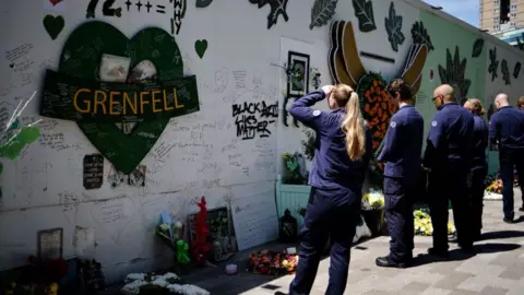 Getty Images Firefighters pay tribute to those who died in June 2021