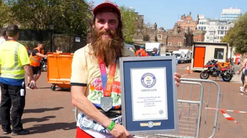 Guinness World Records Rob Pope, who runs in character as Forrest Gump