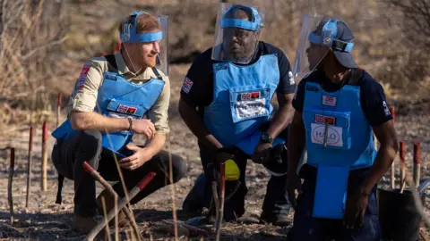 Reuters Prince Harry crouches alongside Halo staff