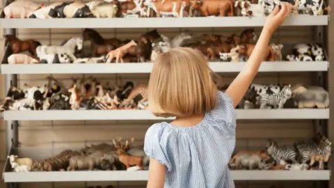 Getty Images Child picking a toy