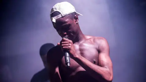 Getty Images J Hus on stage in Glasgow