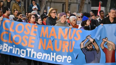 Getty Images Asylum-seeker advocates protest in Melbourne for the closure of Australia's offshore detention centres