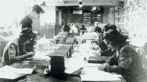 Bletchley Park Trust Women in military uniform at a table in Hut 3 Bletchley Park, Buckinghamshire code-breaking.
