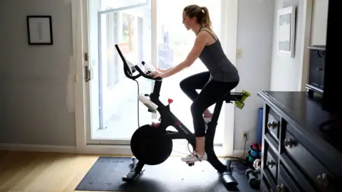 Getty Images Person on a Peloton exercise bike