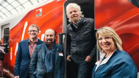 Virgin trains East Coast Sir Richard Branson and team on a train