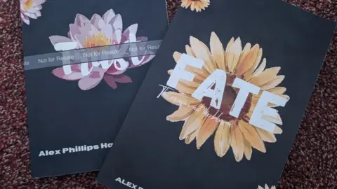 Alex Phillips-Hawkes Two books, they are black covers with flowers on