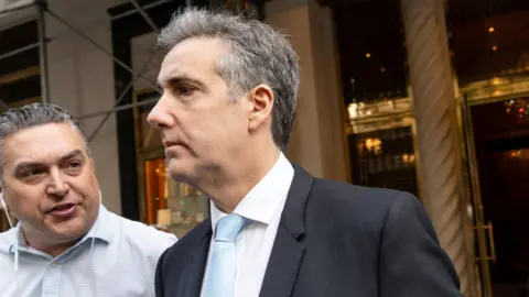 Michael Cohen (centre) enters court on Tuesday