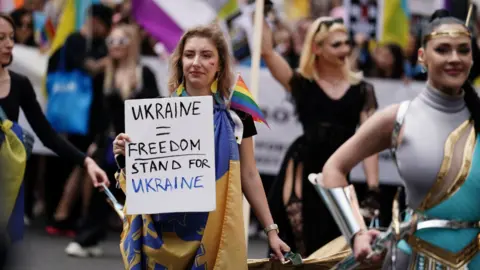 PA Media Woman holds up a placard protesting the freedom of Ukraine