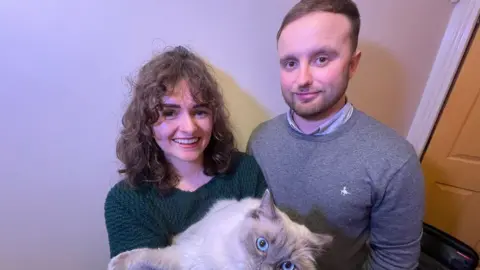 BBC Scott Norton-Ashley with fiancée Jolie Stokes and a cat