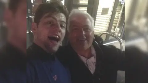 Ross Matthews Ross Matthews pictured with his father. Both of them are smiling at the camera.