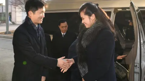 Reuters Hyon Song-wol is greeted by a South Korean official as she arrives at the South's CIQ (Customs, Immigration and Quarantine), just south of the demilitarised zone separating the two Koreas, in Paju, South Korea, on 21 January 2018