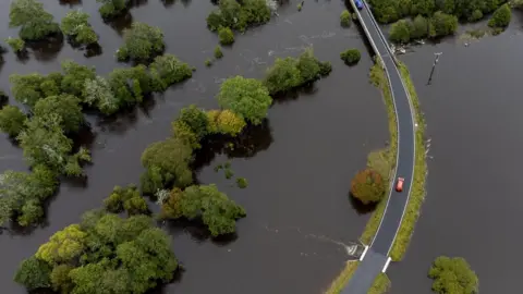 PA Media The River Spey in flood at Kingussie near Aviemore