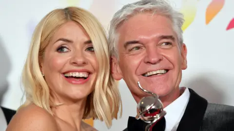 Getty Images Holly Willoughby and Phillip Schofield pose with the award for Live Magazine Show for 'This Morning' in the winners room attends the National Television Awards 2020 at The O2 Arena on January 28, 2020 in London, England