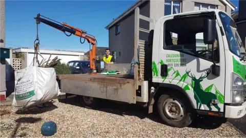 Amanda Barclay Low-loader picking up waste