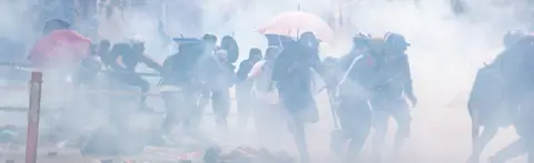 SOPA Images Protesters amid tear gas during the Hong Kong Polytechnic University demonstration