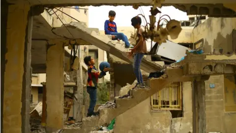 AFP Children play in bomb-damaged building in Gaza City (April 2017)