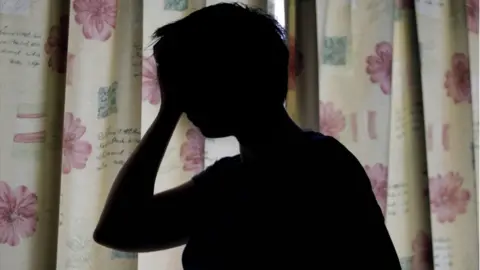 PA Media Silhouette of a woman